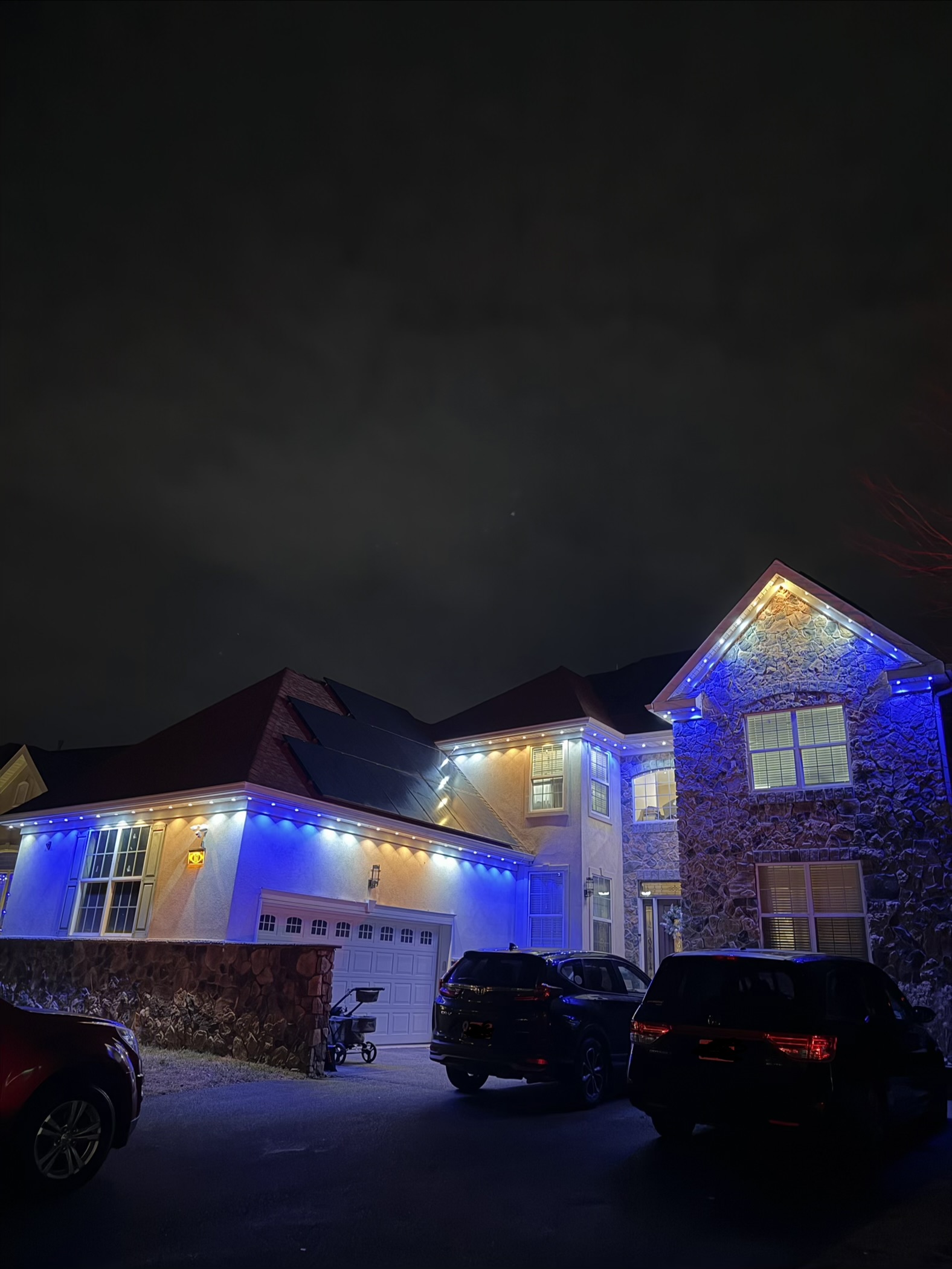 multicolor roofline lights installed on a new jersey home
